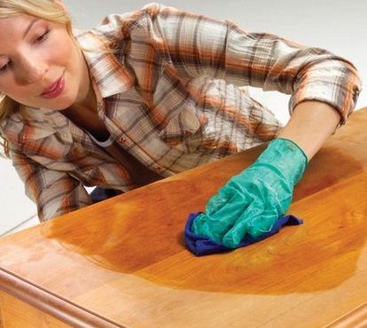 mujer limpiando muebles de madera